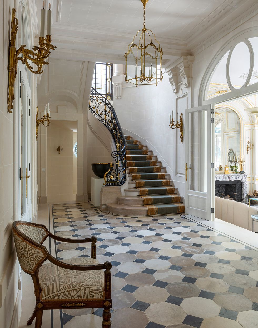 French interior design entryway tile gold iron staircase bryanosullivan
