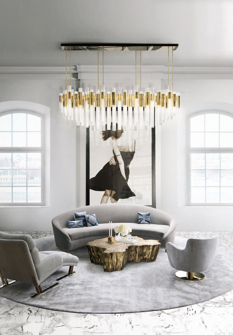 Gray velvet sofa in modern living room with white and gold flute chandelier