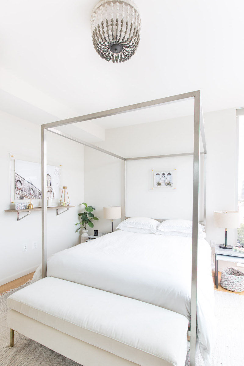Chrome silver canopy bed in bright white bedroom via Rue