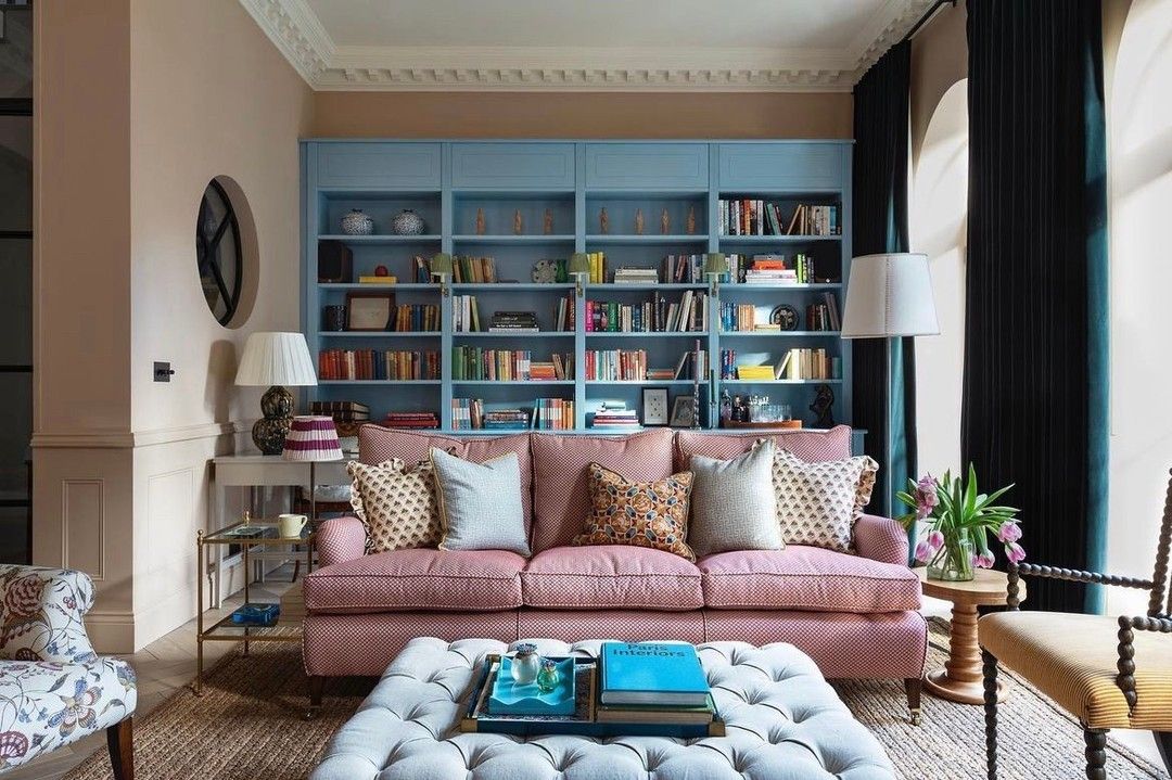 Pink sofa with blue bookshelf living room studioduggan