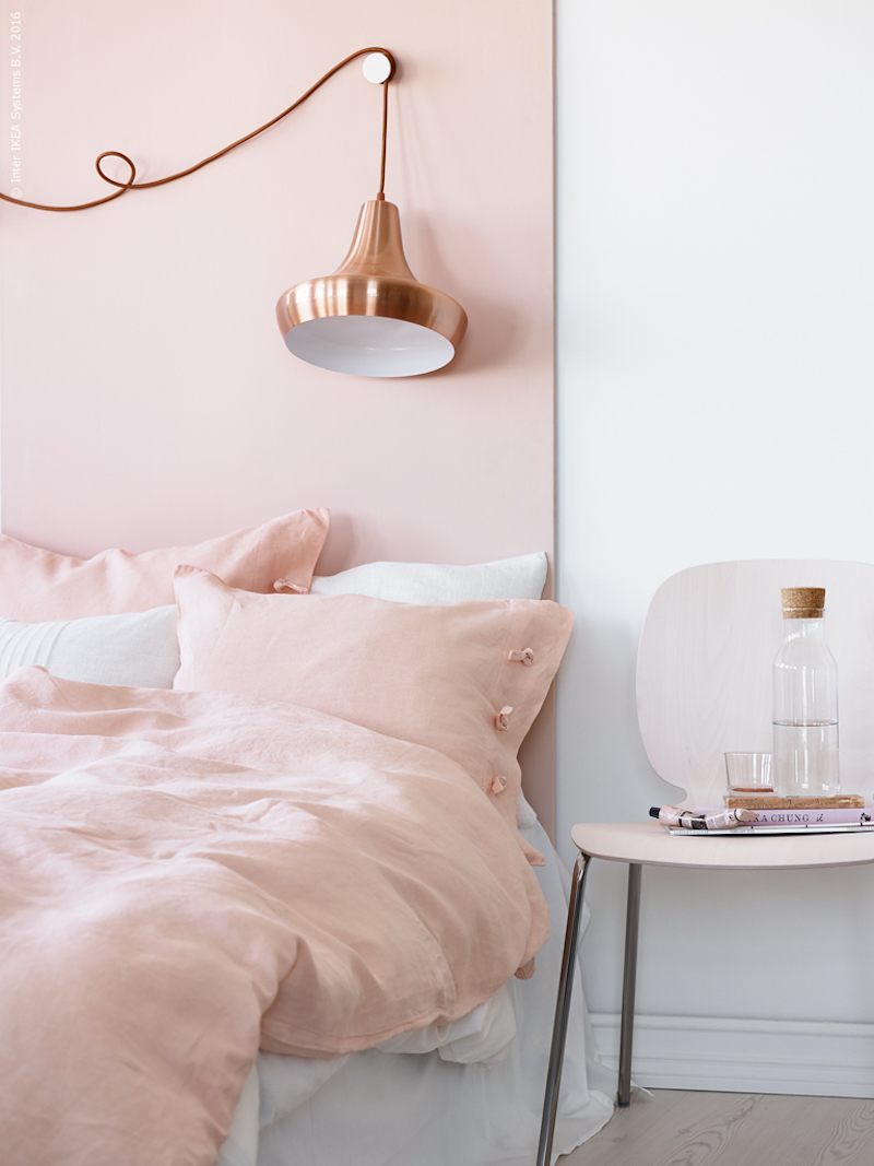 Blush pink bedroom with copper lighting via Ikea