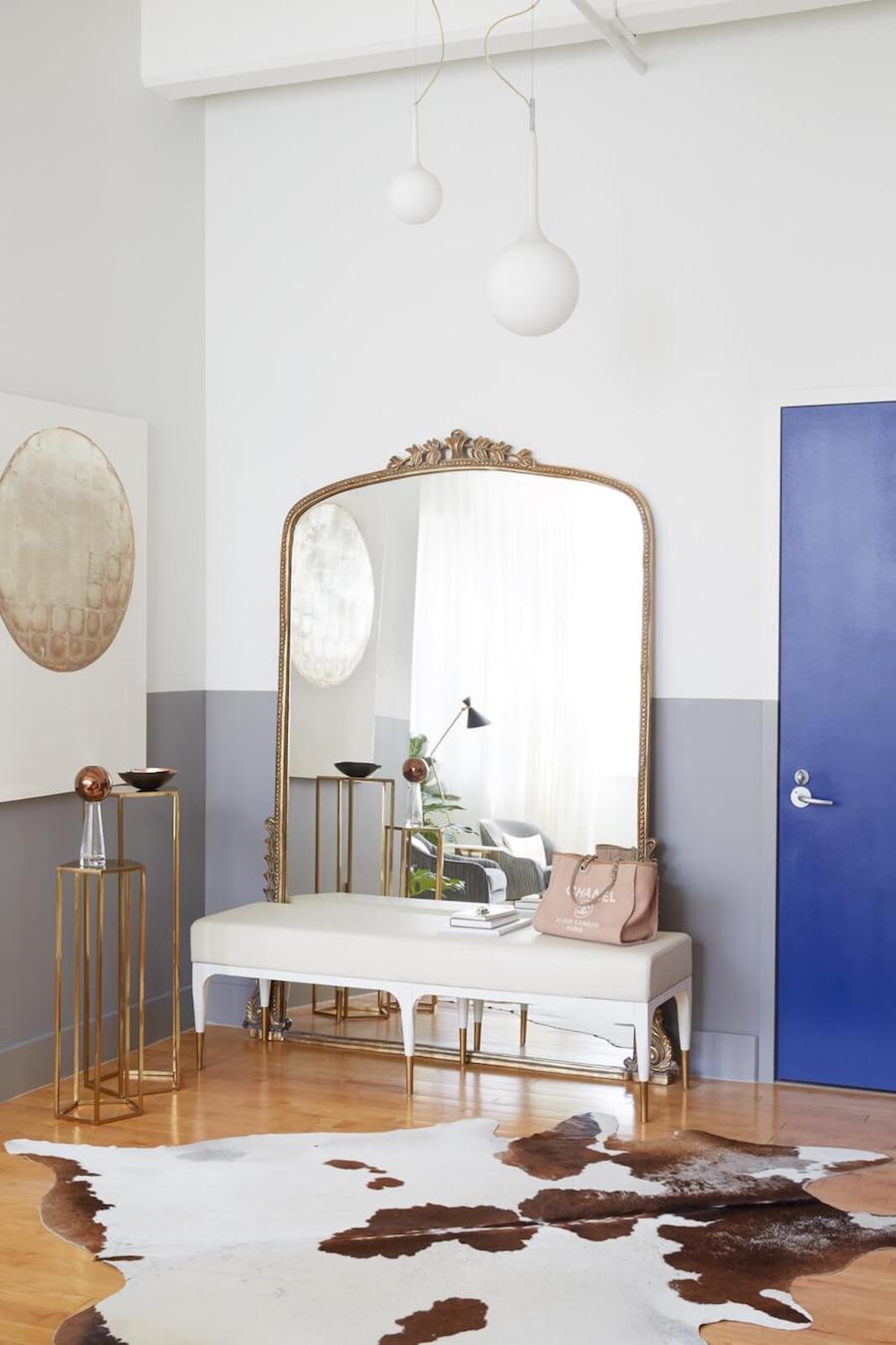 Anthropologie Gleaming Primrose Mirror on floor in Brooklyn loft with white bench and cowhide rug