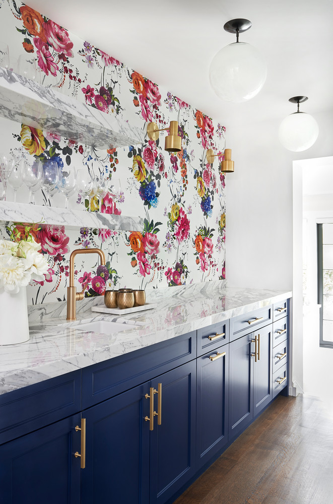 Marble Kitchen Counter, Navy Blue Kitchen Cabinets And Floral Wallpaper Behind Brass Sink