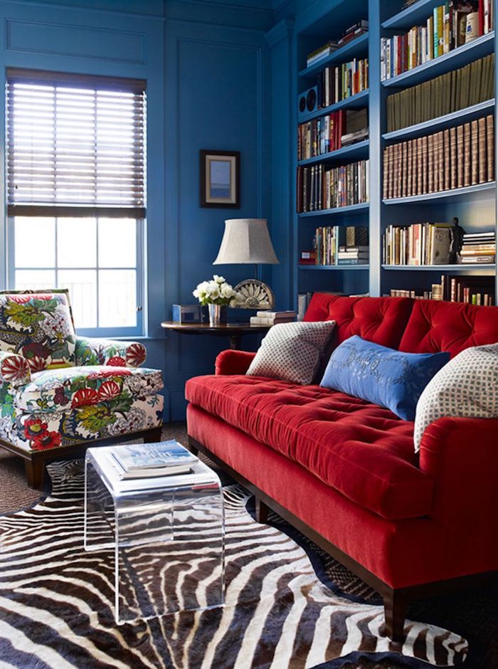 Rose Red Tufted Sofa With Dark Blue Walls And Floral Chair By Katie Ridder