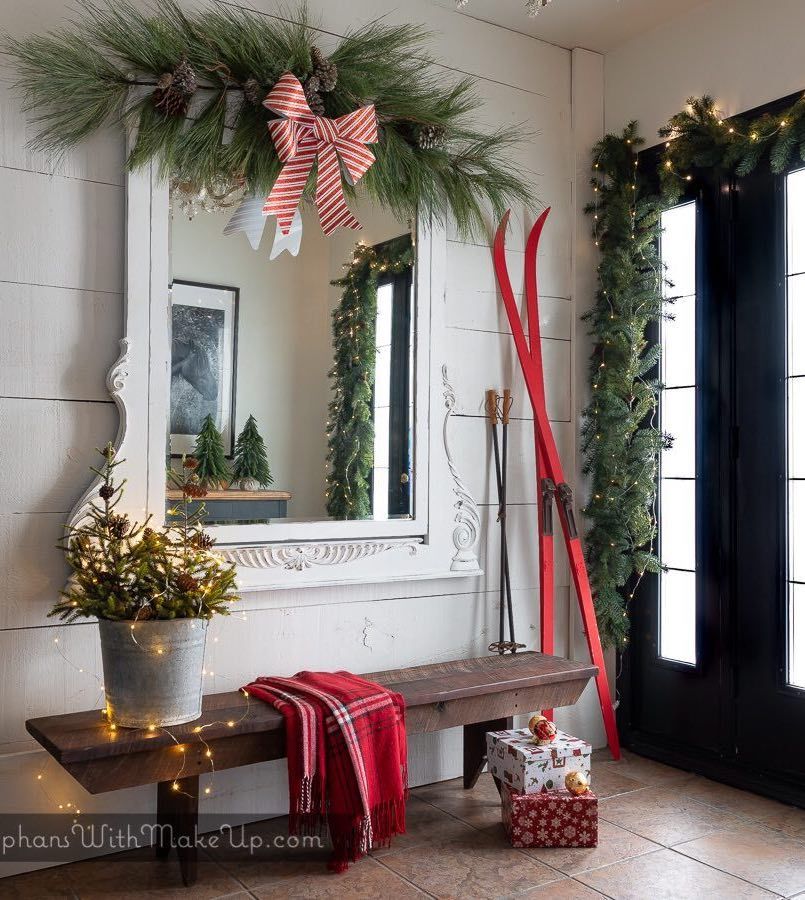 Christmas Entryway with Green Garland and Red Skis via @orphanswithmakeup #ChristmasDecor #ChristmasHome