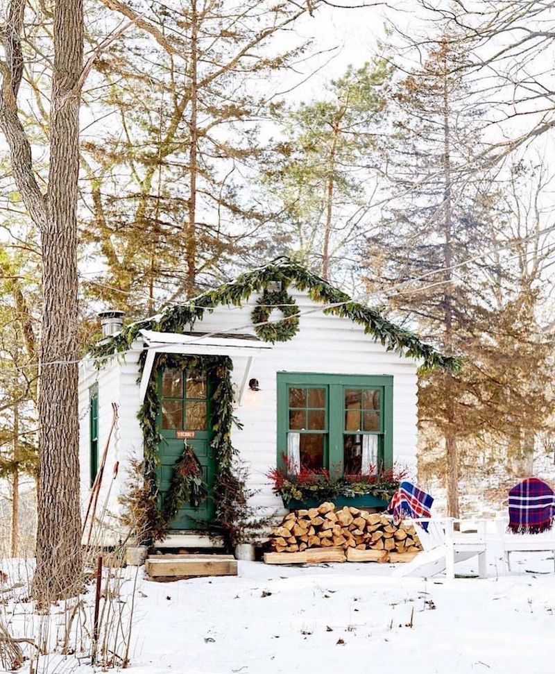 Christmas cabin in the woods decorated with Green garlands