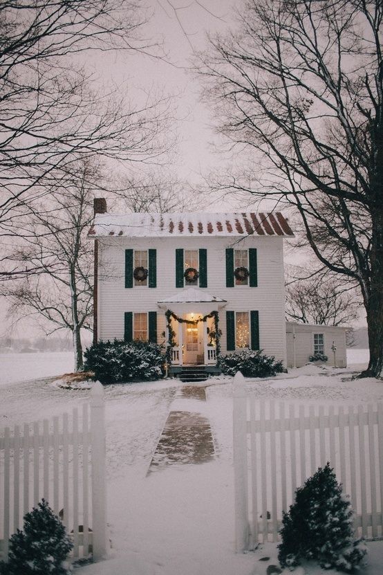 Cute white house with wreaths on the windows - Christmas House Decor