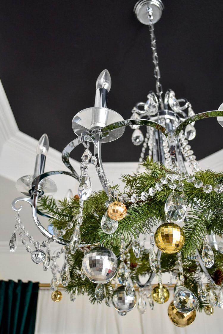 Dining Room Chandelier Decorated for Christmas via @monicawantsit #ChristmasDecor #ChristmasDiningRoom