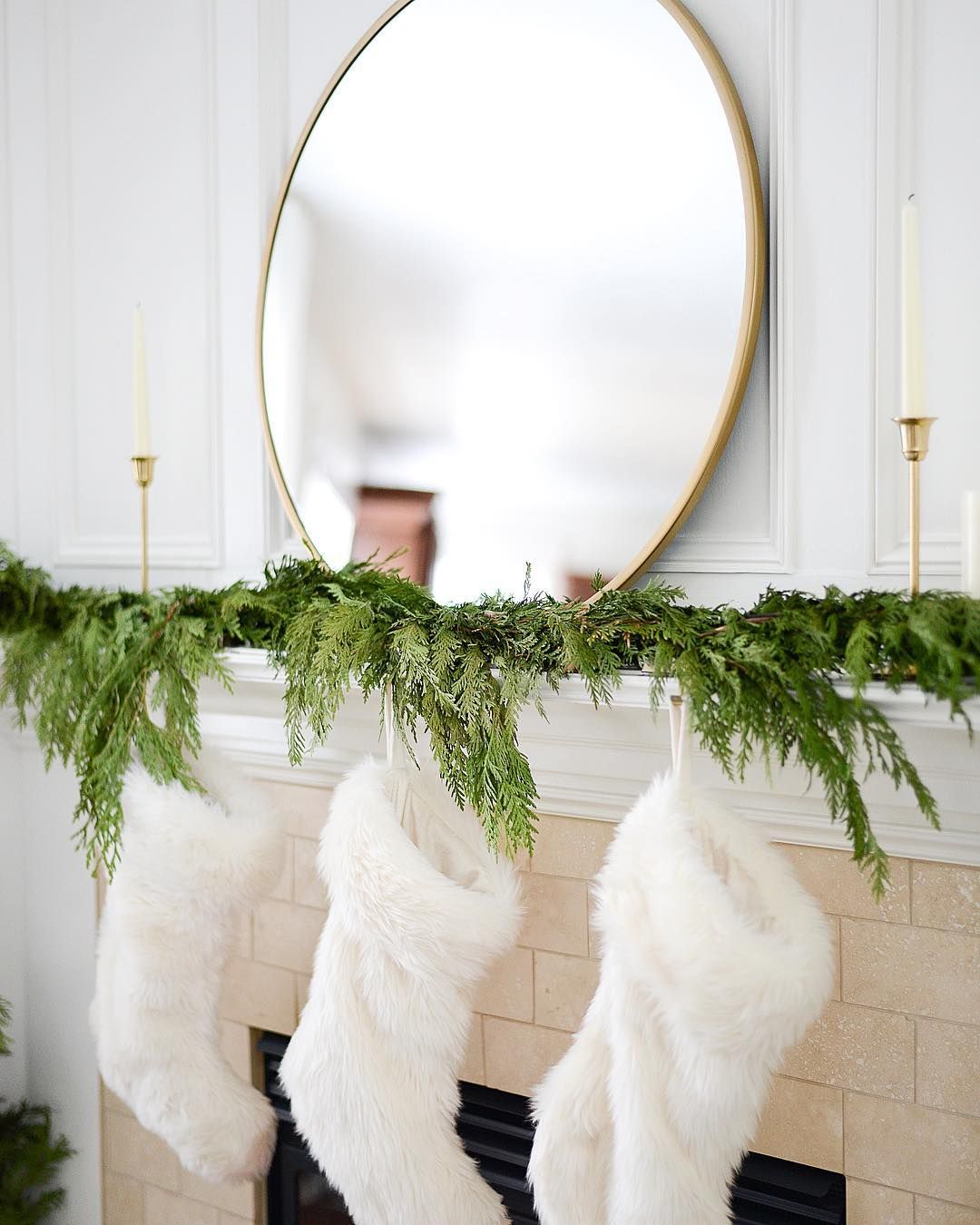 Fresh greenery, white stockings, gold mirror Christmas Mantel via @house_of_trinh_setting