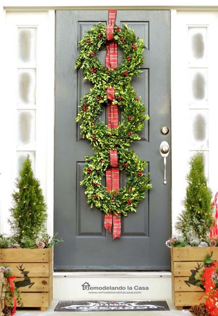 Front door with three boxwood wreaths Christmas Decor via remodelandolacasa