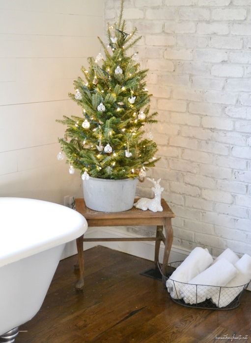 Mini Christmas Tree next to Bathtub via beneathmyheart #ChristmasDecor #ChristmasBathroom