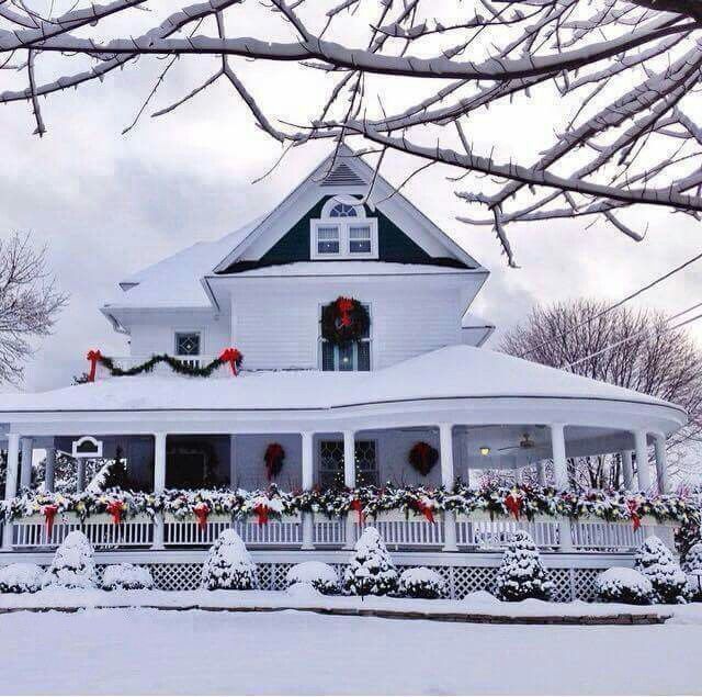 Snowy house with Christmas garland decor outside