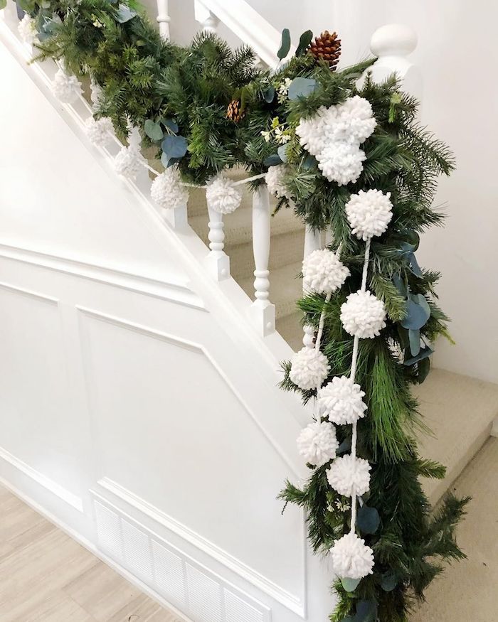 White pom pom stair garland for Christmas via @mildlyminimal