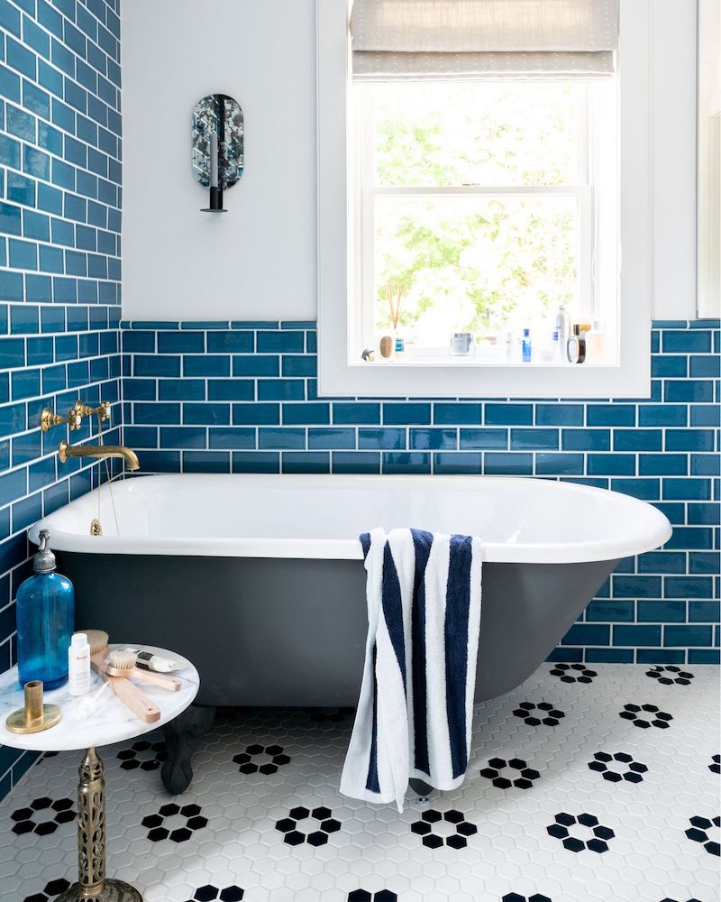 Black bathtub with Blue subway tile in a coastal bathroom