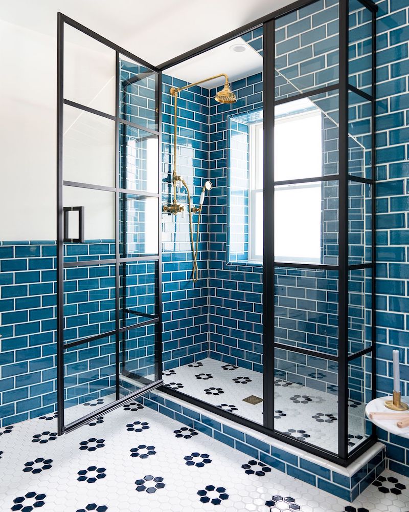 Blue subway tile stand in shower in a beach home bathroom