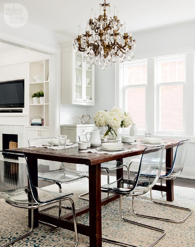 French Crystal Chandelier above Wood Dining Room Table with Ikea Ghost Chairs