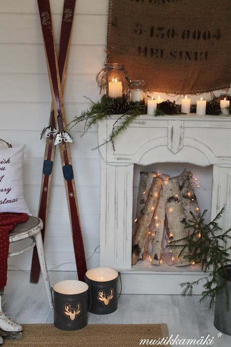 Rustic winter fireplace decor with old skiis via mustikkamaki