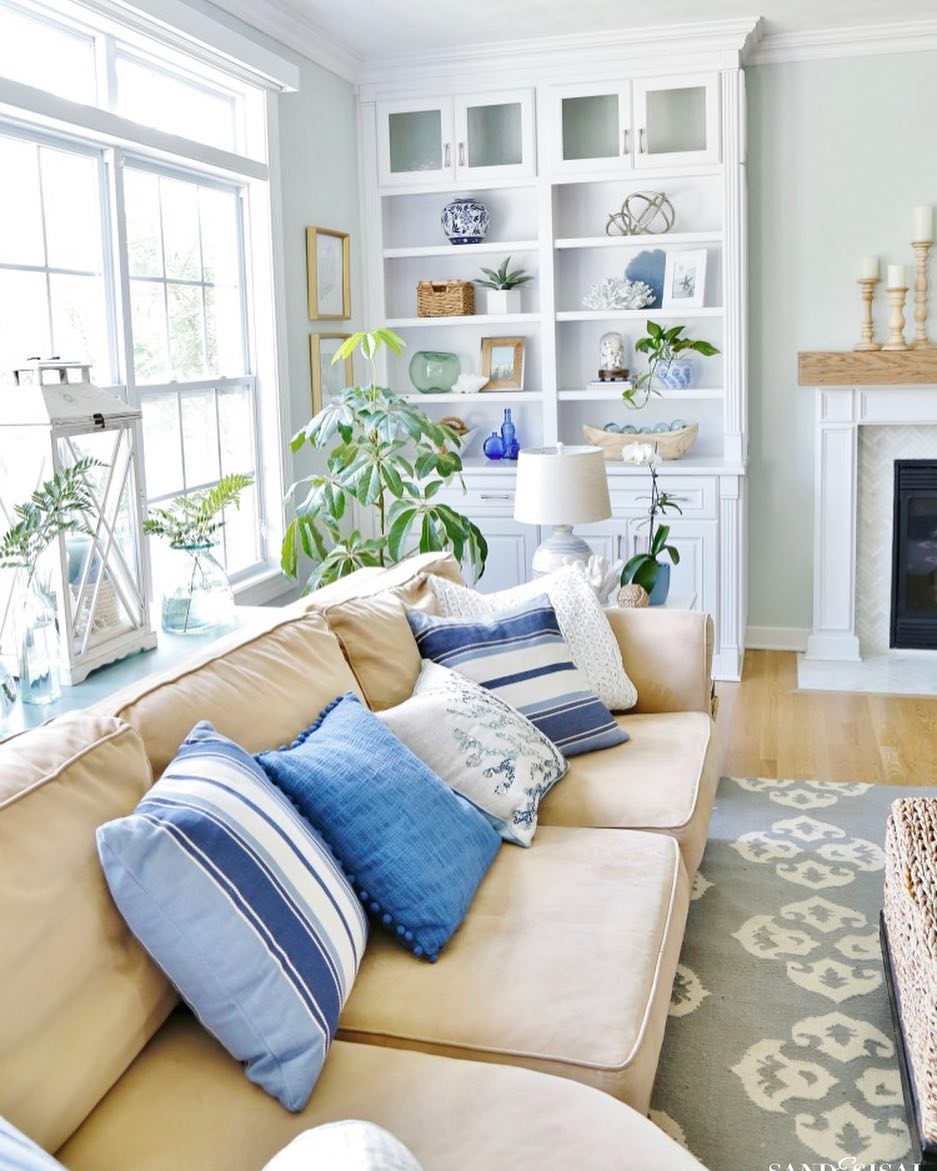 Coastal throw pillows on beige sofa perfect for a beach home or summer house via @sandandsisal