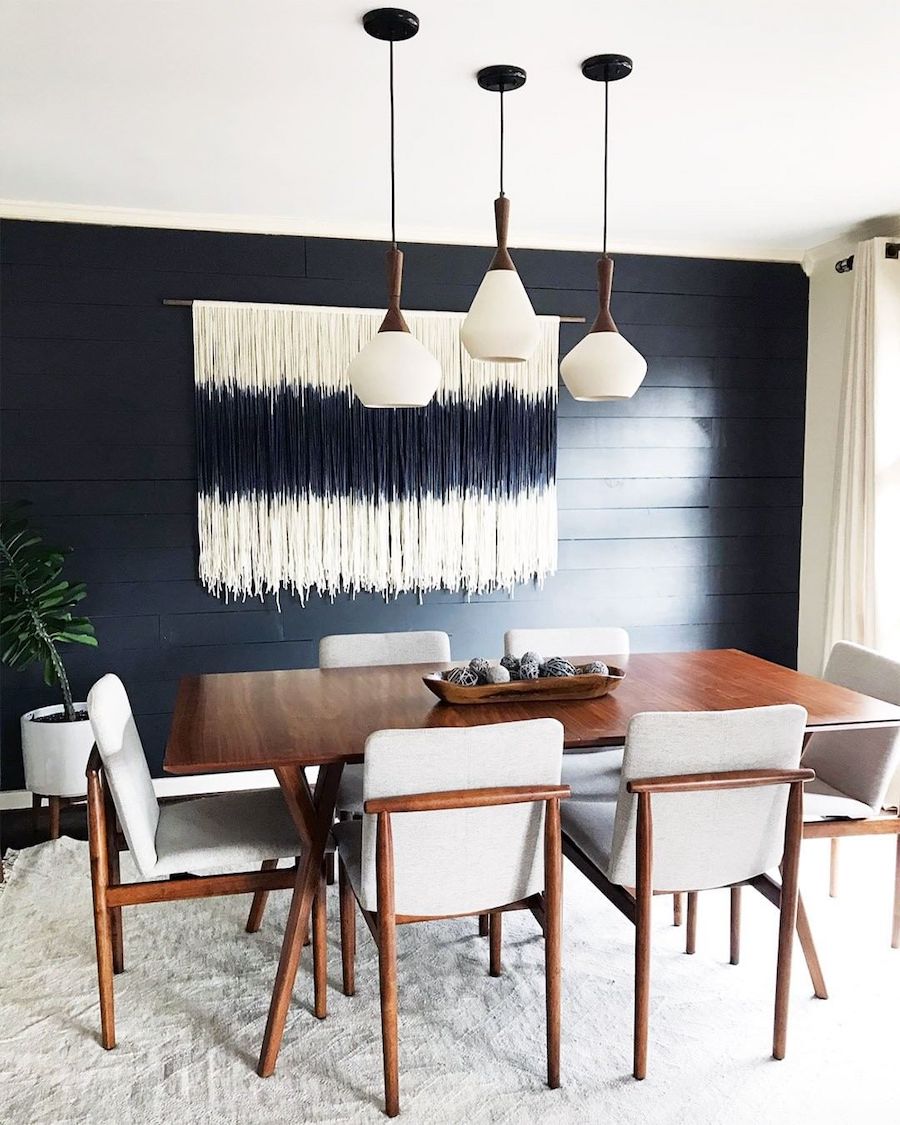 Mid-century modern dining chairs with gray seat cushion, gray rug and bold blue accent wall via @adidstudio