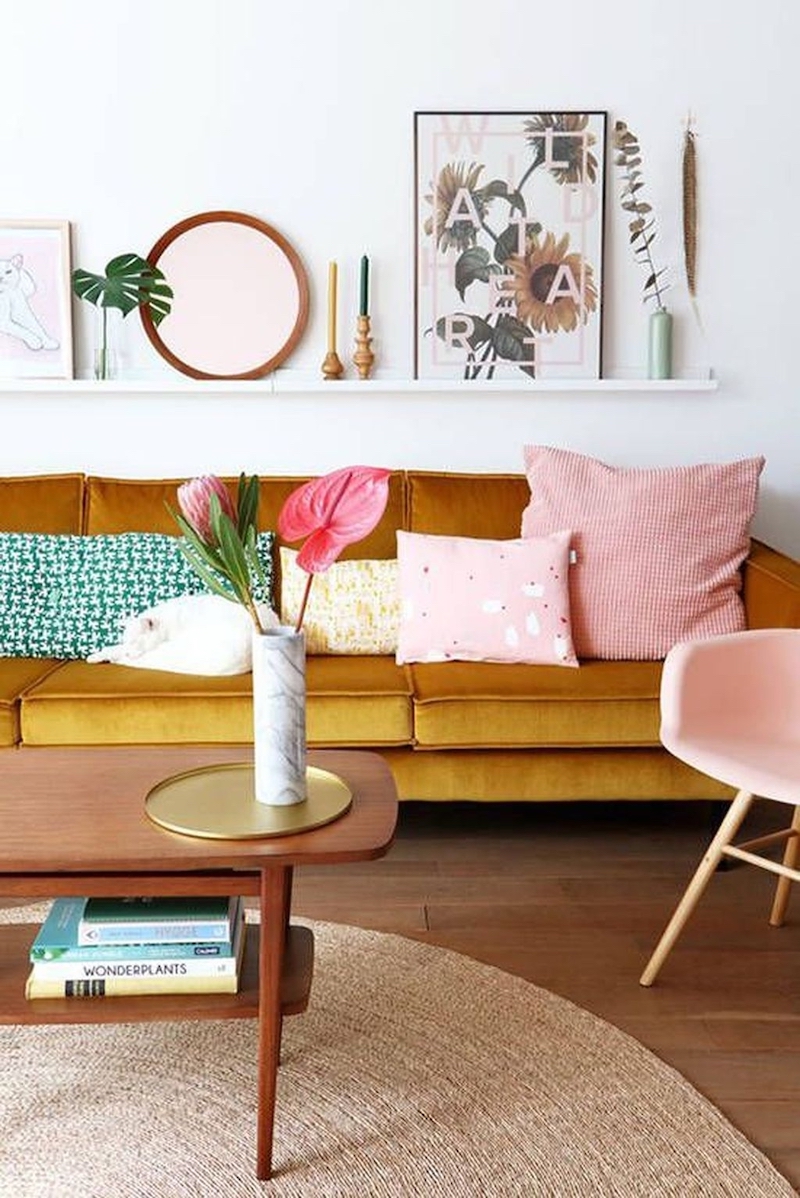 Mustard yellow mid-century modern sofa and two-tier wood coffee table