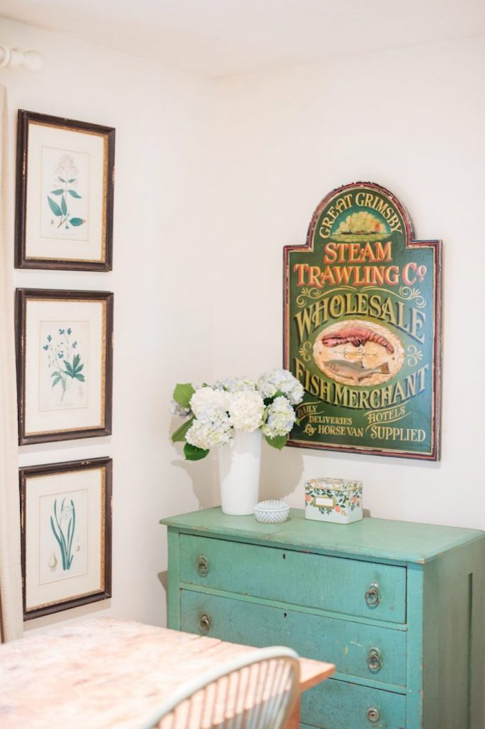 Vintage grocery store sign decor and turquoise cabinet via theeverygirl