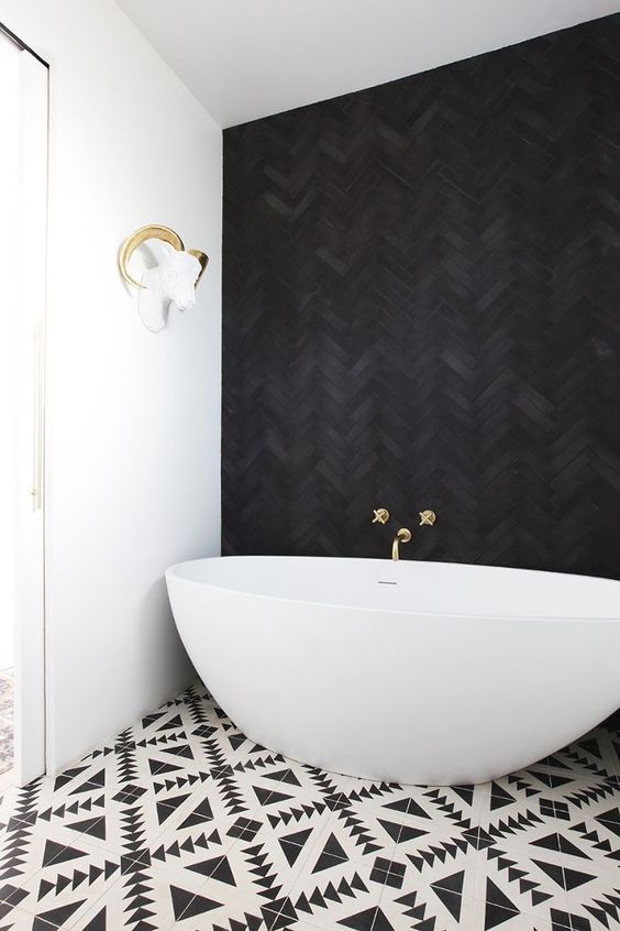 Bathroom with Black Herringbone Tile on wall with freestanding bathtub