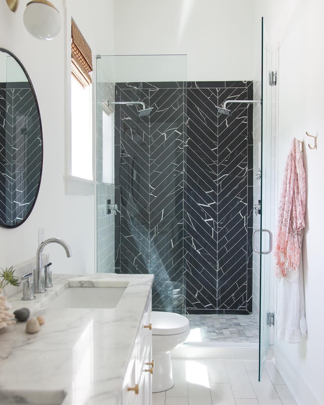 Bathroom shower with black marble herringbone tiles via @hannahcrowell