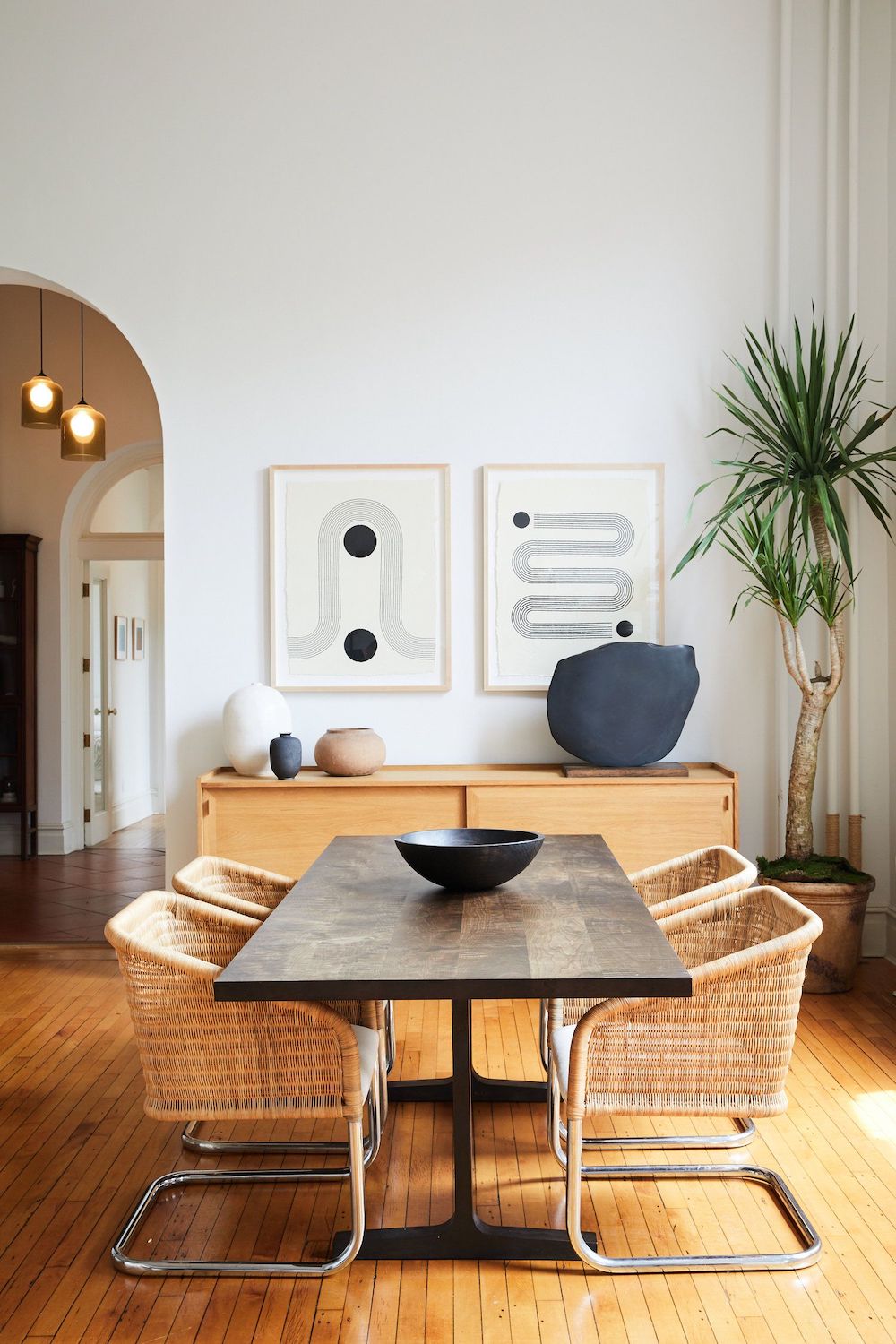 Dining Room with Dark wood table and wicker chairs via spaceexplorationdesign