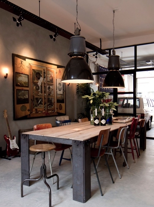 Industrial wooden stool and metal dining chairs in industrial dining room