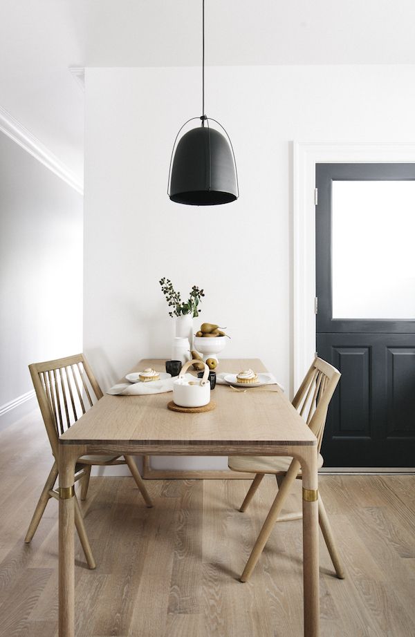 Scandinavian Dining Room with warm natural wood dining table and black pendant light via Luft