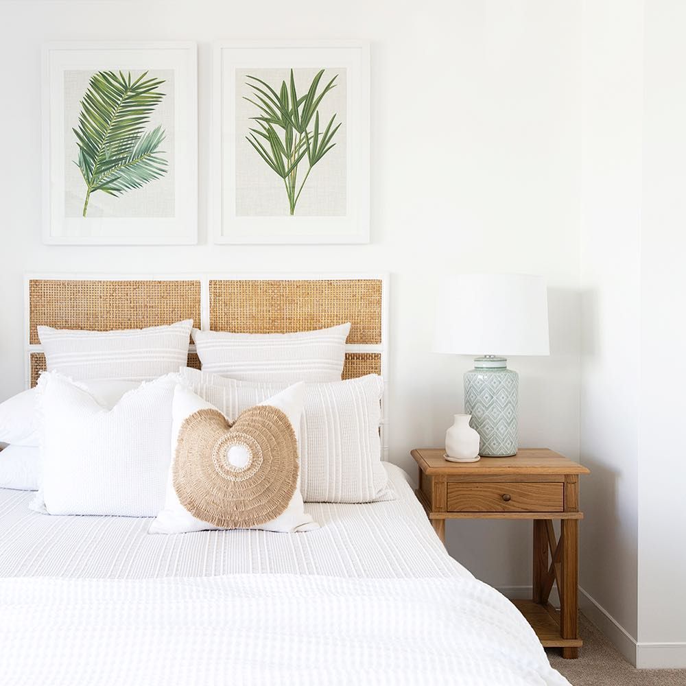 Coastal bedroom with palm art and cane-back headboard @donna_guyler_design