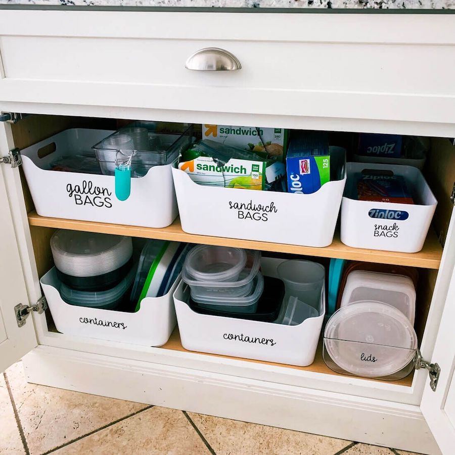 White trays with labels for kitchen cabinet organization via thirtyhandmadedays