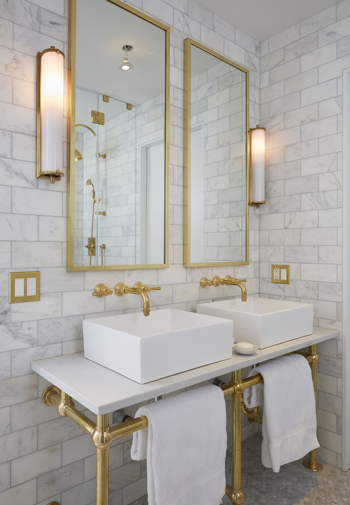 Marble Bathroom with double vanity and brass fixtures via Grant Davis Thompson
