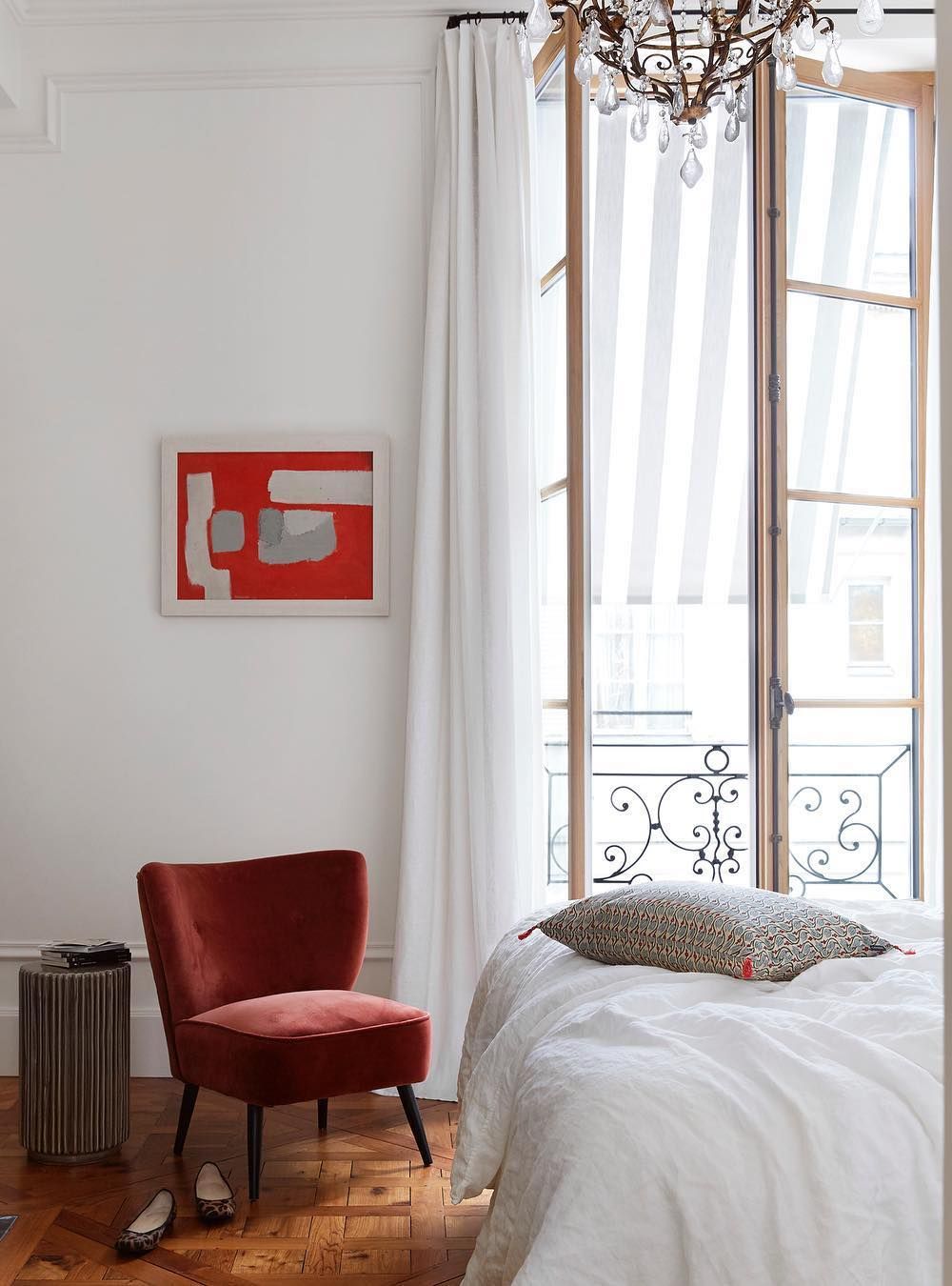 Parisian Bedroom with Red accent chair and wall art via @abkasha