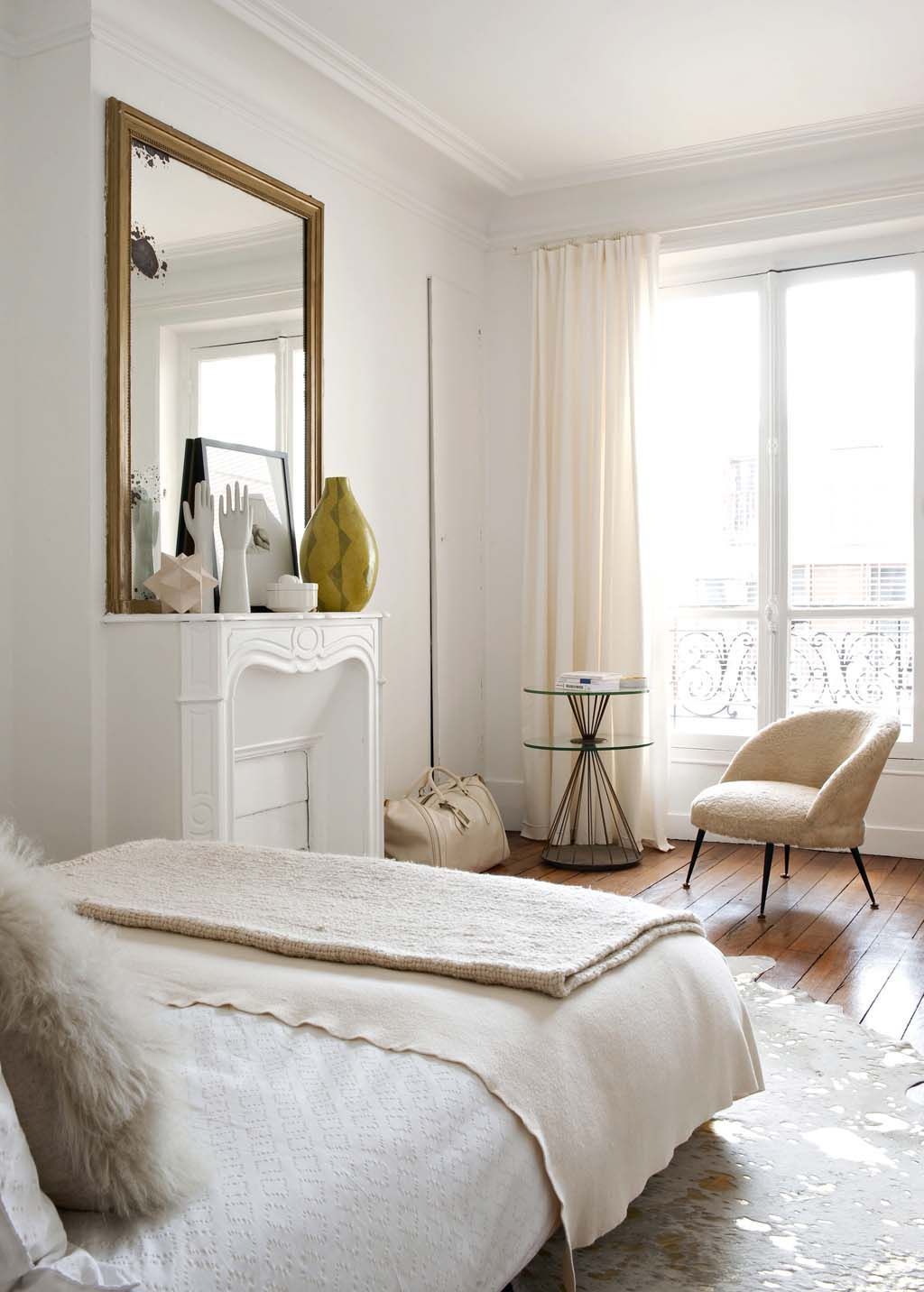 Parisian bedroom with beige accent chair via CoteMaison Emilie Bonaventure