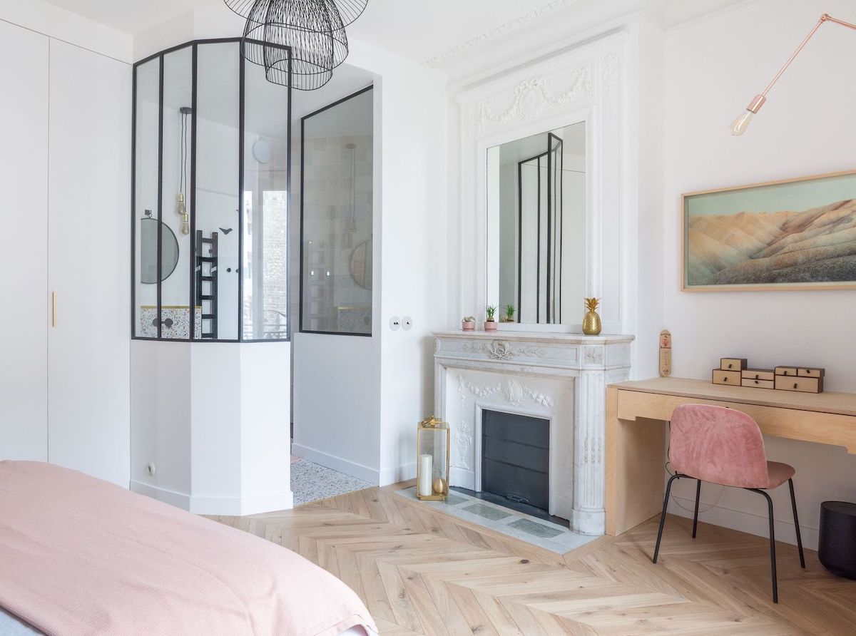 Parisian bedroom with built-in desk and pink chair via Quitterie de Pascal