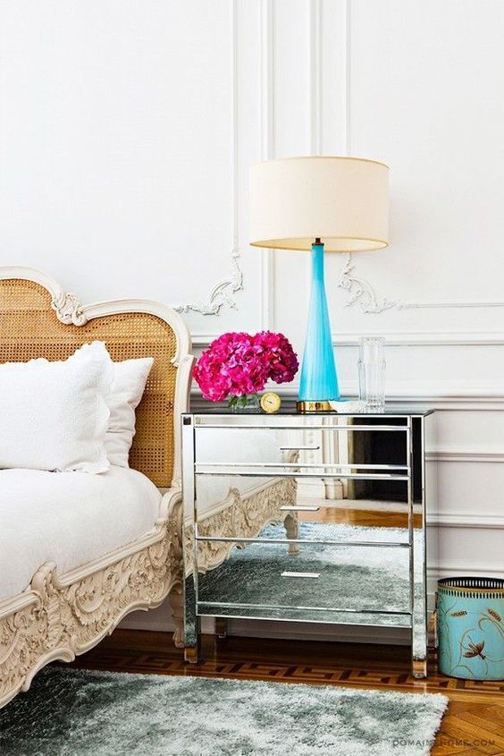 Parisian bedroom with mirrored nightstand and cane headboard