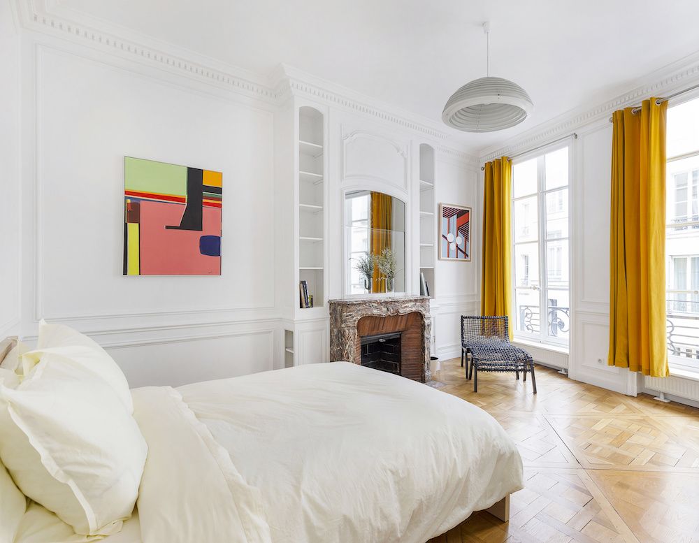 Parisian bedroom with yellow curtains via Havenin Saint Honore