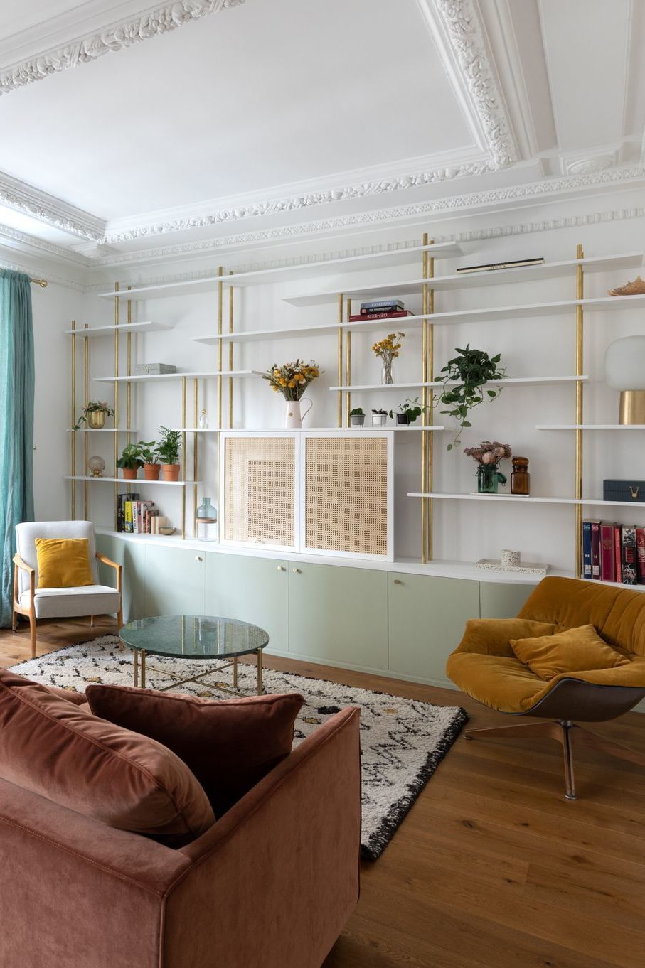 Parisian living room mid-century modern with burgundy sofa via Charlotte Fequet CoteMaison