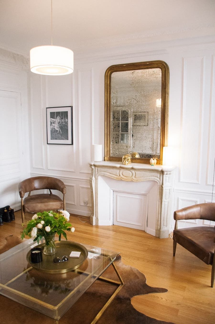 Parisian living room with brown leather accent chairs