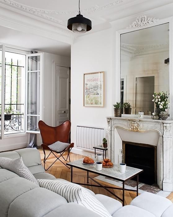 Parisian living room with brown leather butterfly chair