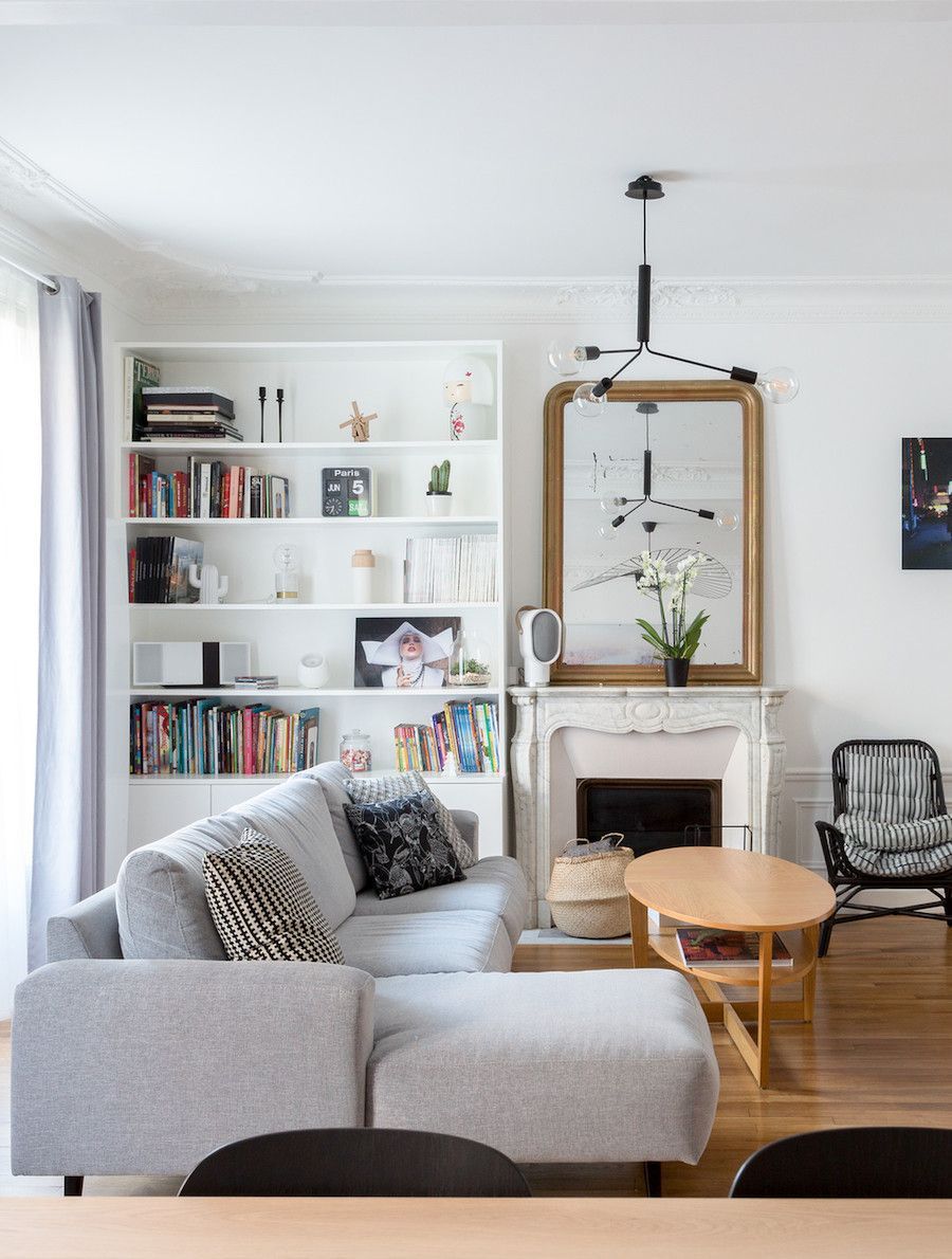 Parisian living room with gray sectional sofa via Mon Concept Habitation