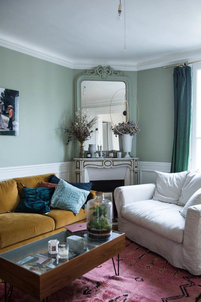 Parisian living room with green walls and mustard yellow sofa via thesocialitefamily sabina socol
