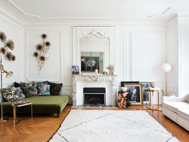 Parisian living room with marble fireplace and green velvet ottoman via Nuevo Estilo Aroussia Chamakh