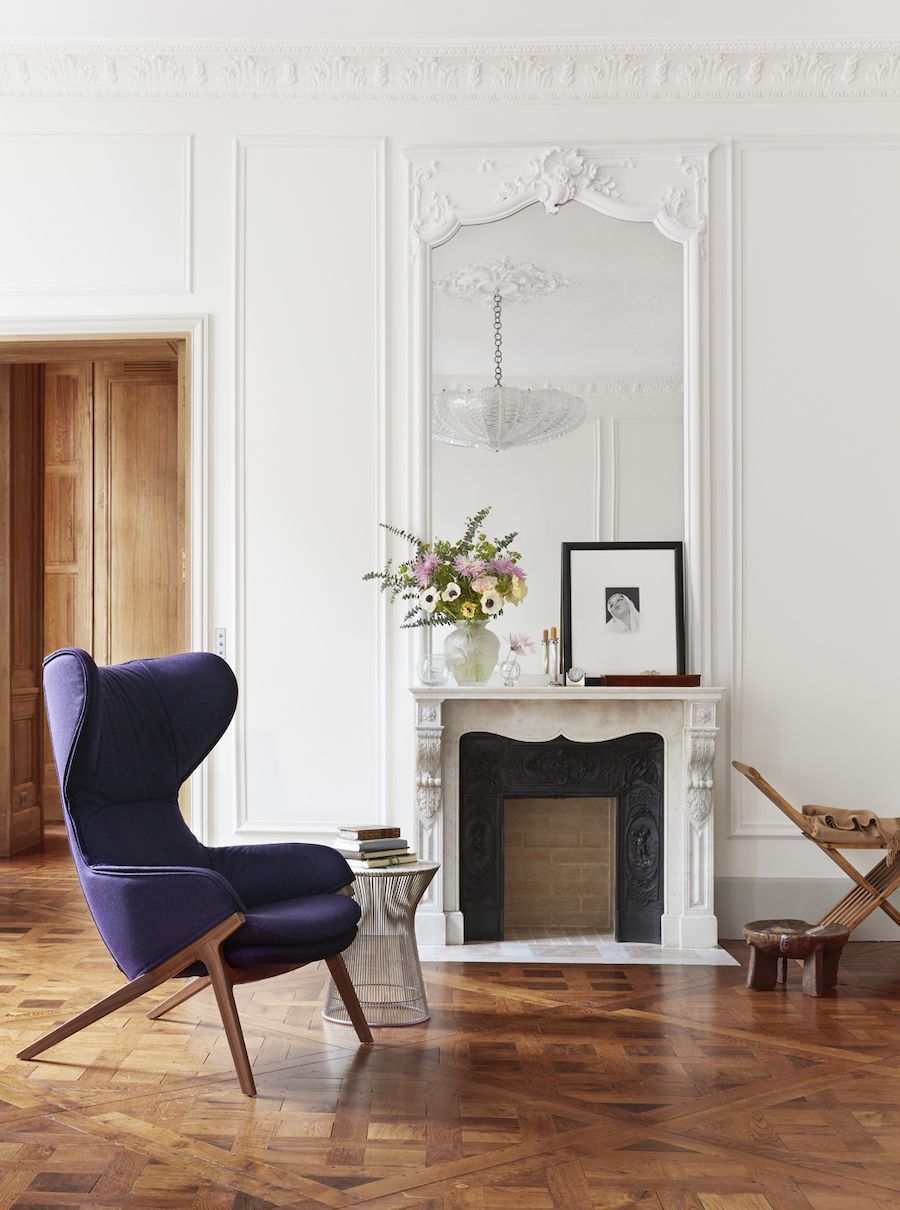 Parisian living room with mid-century modern purple accent chair via A + B Kasha