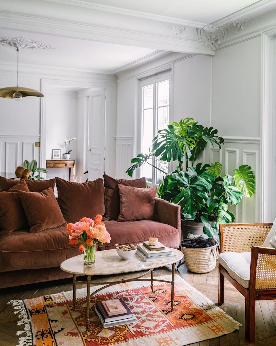 Parisian living room with velvet burgundy sofa by AptLafayette