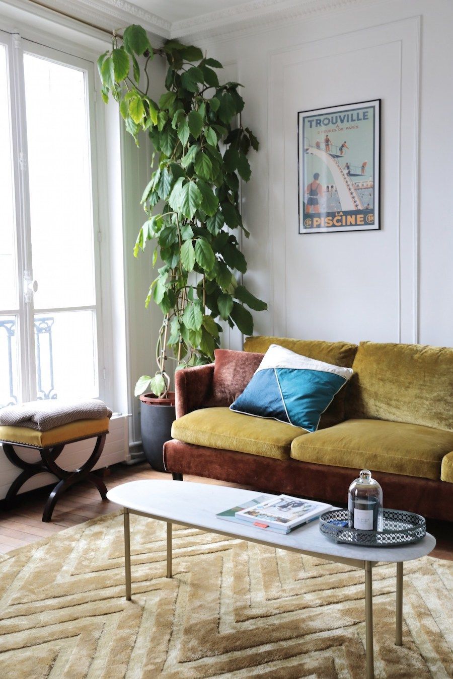 Parisian living room with velvet sofa and mid-century rug via Hello-hello Camille Omerin