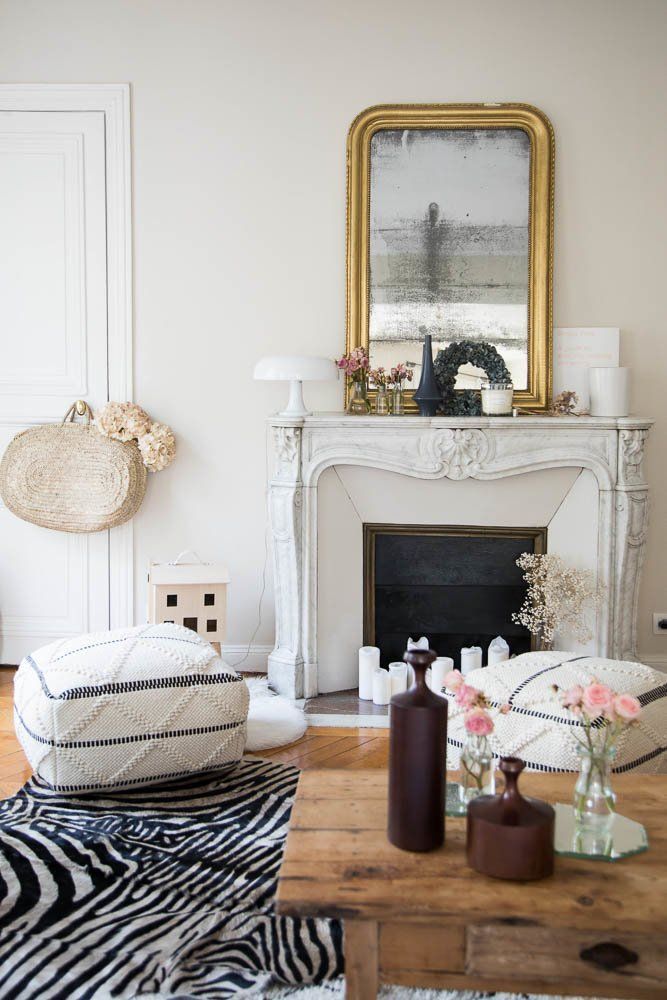 Parisian living room with wood coffee table and bohemian floor poofs via The Socialite Family Audrey Borrego