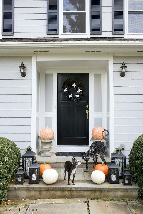 Black front door Halloween decor via drivenbydecor