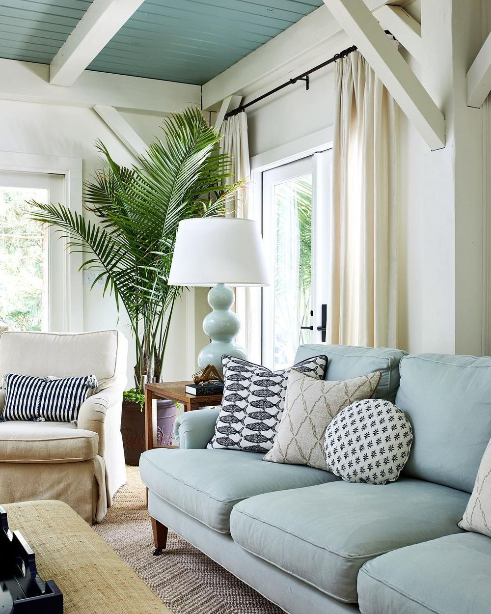 Coastal Sofas - Beach home with blue linen sofa and indoor palm @studiomiel